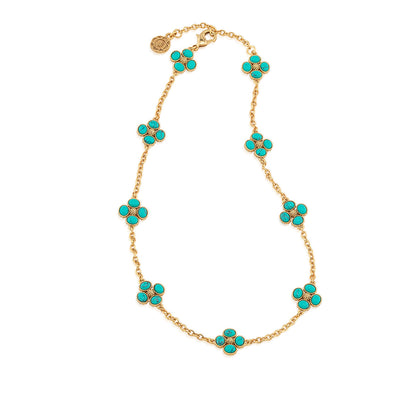 The Juliska Capucine De Wulf Berry Clover Double Sided Necklace showcases eight double-sided berry clovers in turquoise floral clusters, evenly spaced along its gold station chain.