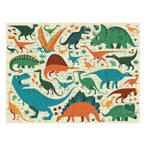 The Dinosaur Dig 100 Piece Double Sided Puzzle by Chronicle Books is an illustrated, double-sided puzzle featuring a variety of colorful dinosaurs such as T-Rex, Stegosaurus, Triceratops, and Pterodactyl set against a light background. Flip it over to discover dinosaur skeletons for an exciting Dinosaur Dig adventure.