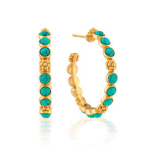The Juliska Capucine De Wulf Berry Gem Medium Hoop Earrings feature gold hoops adorned with round turquoise stones and textured gold bead accents, ideal for lovers of feminine jewelry, shown against a white background.