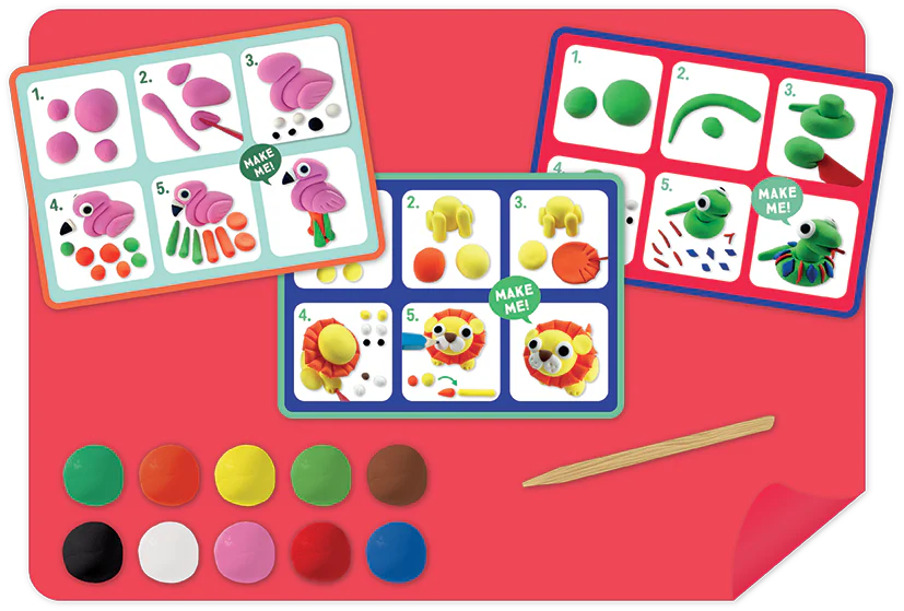 The Floss and Rock Clay & Play - Jungle set includes three instruction cards, colorful air dry clay pieces, and a wooden sculpting tool on a red surface—perfect for sparking creativity.