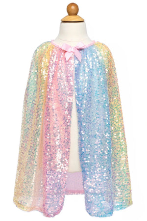 A mannequin showcases the Great Pretenders Ombre Sequin Cape, a kids' accessory featuring iridescent pastel rainbow sequins and a pink ribbon tie—perfect to pair with a matching tutu.