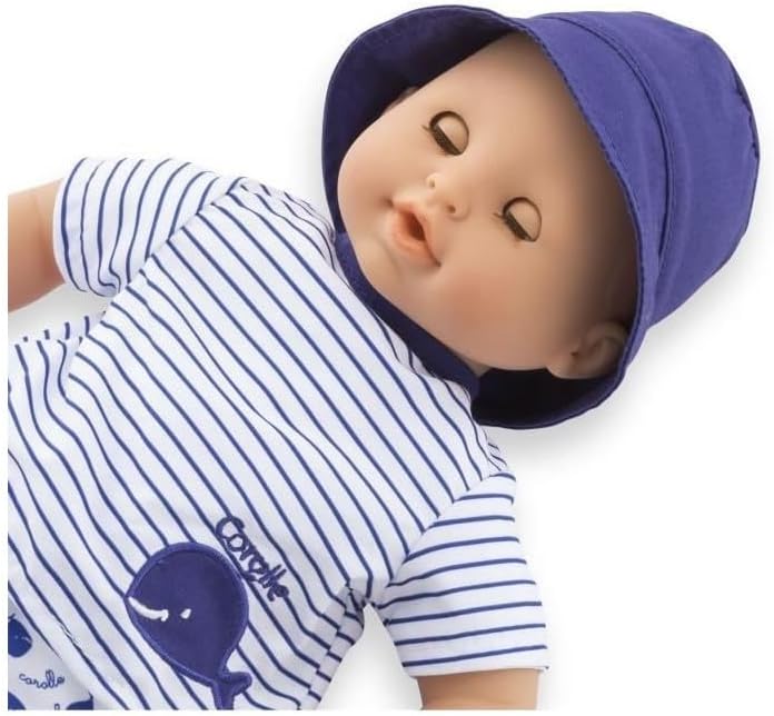 Corolle’s Bebe Bath Doll comes dressed in a blue and white striped shirt with a whale graphic and a blue hat, eyes closed as if sleeping—the perfect companion for water play.
