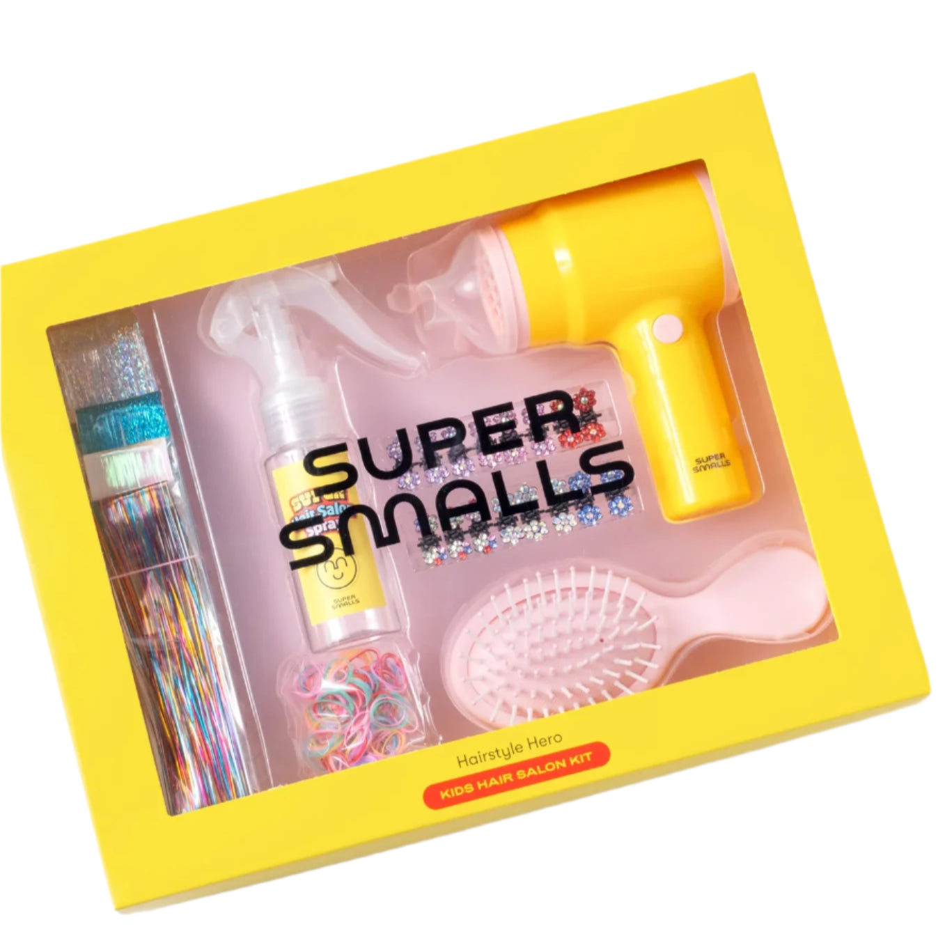 The "Hairstyle Hero Salon Kit" by Super Smalls comes in yellow and includes a toy hairdryer, spray bottle, detangling brush, colorful hair bands, and glittery clips—everything your child needs for fun styling adventures in vibrant packaging.