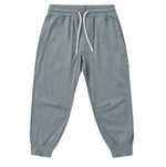 The Boys’ Century Tech Jogger by Rylee & Cru, featuring a gray relaxed fit, elastic waistband with white drawstring, side pockets, and cuffed ankles, is displayed laid flat on a white background.