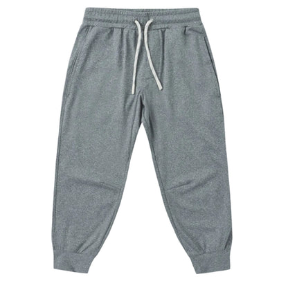 The Boys’ Century Tech Jogger by Rylee & Cru, featuring a gray relaxed fit, elastic waistband with white drawstring, side pockets, and cuffed ankles, is displayed laid flat on a white background.