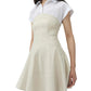 A woman wears the Simkhai Sundae Linen Mini Dress, featuring a structured bodice and flared skirt, layered over a short-sleeved white collared shirt.