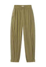 The Articulated Vented Pant by CO is crafted from lightweight technical fabric in light olive green, featuring crinkled texture, elasticated waist, zip pockets, side stripes, and adjustable cuffs.