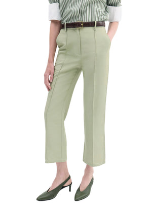 Person wearing CO Cropped Flared Pant in light green, a brown belt, a green and white striped shirt with rolled sleeves, and green slingback heels.