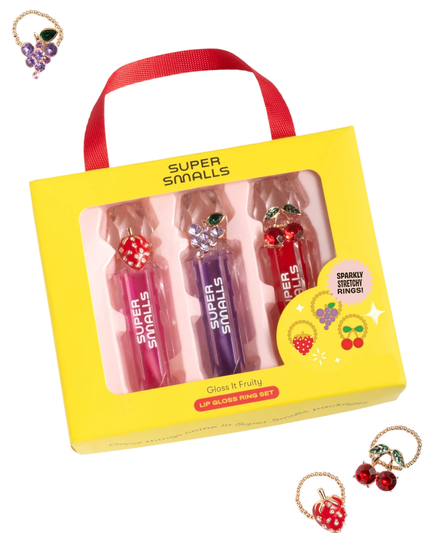 The Super Smalls Gloss it Fruity Lip Gloss Ring Set includes a trio of fruity lip glosses in pink, purple, and red tubes plus three colorful rings, shown both inside and outside the packaging.