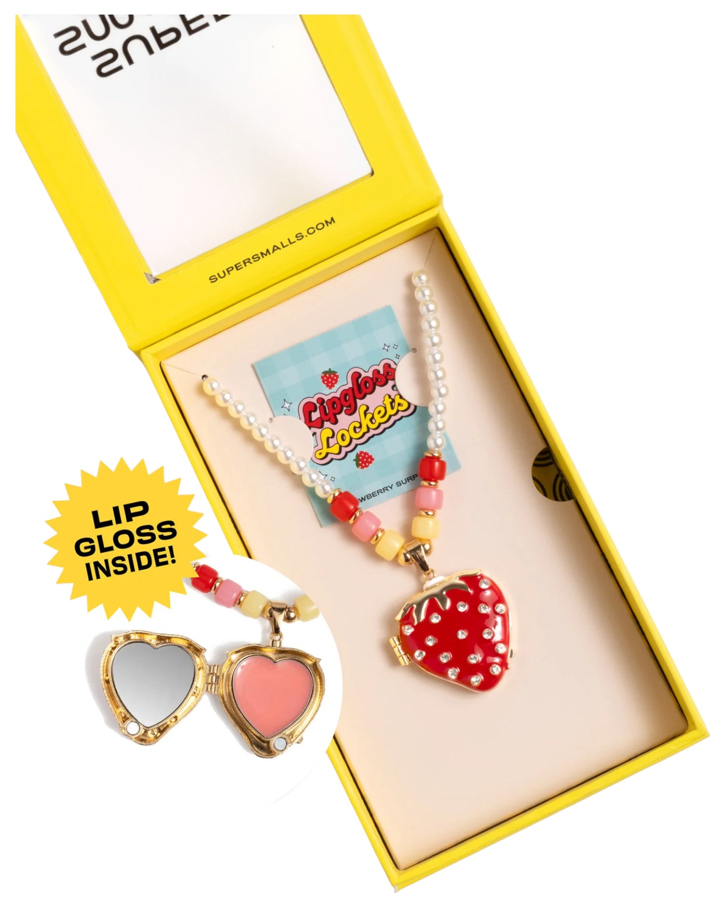 The Super Smalls Strawberry Surprise Lipgloss Locket is a heart-shaped kids’ necklace with a pearl and bead chain in a yellow box. Open the locket to reveal two glossy Strawberry lip gloss shades for fun beauty play.