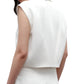 A woman is shown from the back wearing the TWP Katie Cropped Tailored Vest in white coated viscose linen with matching white pants, set against a plain white background.