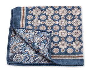 A R. Hanauer Medallion Paisley Pocket Square in blue and white with a beautiful pattern, crafted from luxurious silk. One corner flips to reveal an intricate design, showcasing the craftsmanship of being made in Italy.