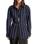 TWP The Night We Met Stripe Shirt in striped cotton with dark blue and white vertical stripes, worn with a silver rectangular pendant on a leather cord.