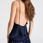A person seen from behind wearing the blueberry crepe back silk satin Sari Tank with a deep scoop back and spaghetti straps.