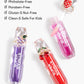 Three jewel-inspired lip glosses from Super Smalls’ Gloss it Rainbow Lip Gloss Ring Set, in purple, pink, and red—cruelty-free, phthalate-free, paraben-free, gluten- and nut-free, and safe for kids.