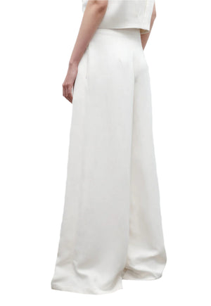 A person is shown from the back wearing the TWP Drew Pant, high-rise wide-leg pants made from European flax linen, paired with a matching top against a white background.