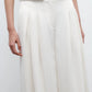 A person wears TWP's Drew Coated Viscose Linen Pant, a high-rise wide-leg style, paired with a matching sleeveless top, shown from waist to mid-thigh.