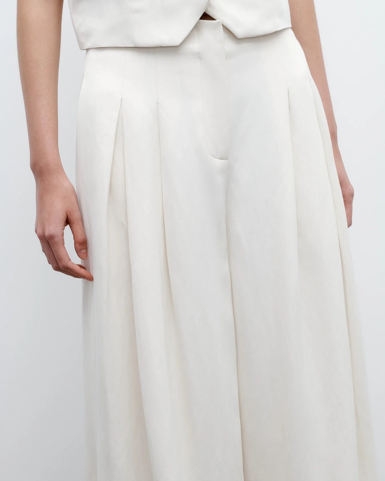 A person wears TWP's Drew Coated Viscose Linen Pant, a high-rise wide-leg style, paired with a matching sleeveless top, shown from waist to mid-thigh.