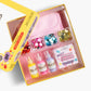 Introducing the Super Smalls Preppy Purse Gemify™ Craft Kit—a cheerful yellow box featuring a pink purse, bottles of colorful gem glue, assorted large plastic gems, and an exclusive “Preppy Purse” label. Perfect for anyone who loves creative projects and wants to design their own stylish accessory!.