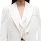 A model wearing the Perfect Boyfriend Blazer by TWP over a white top, shown from shoulders to waist against a plain background.