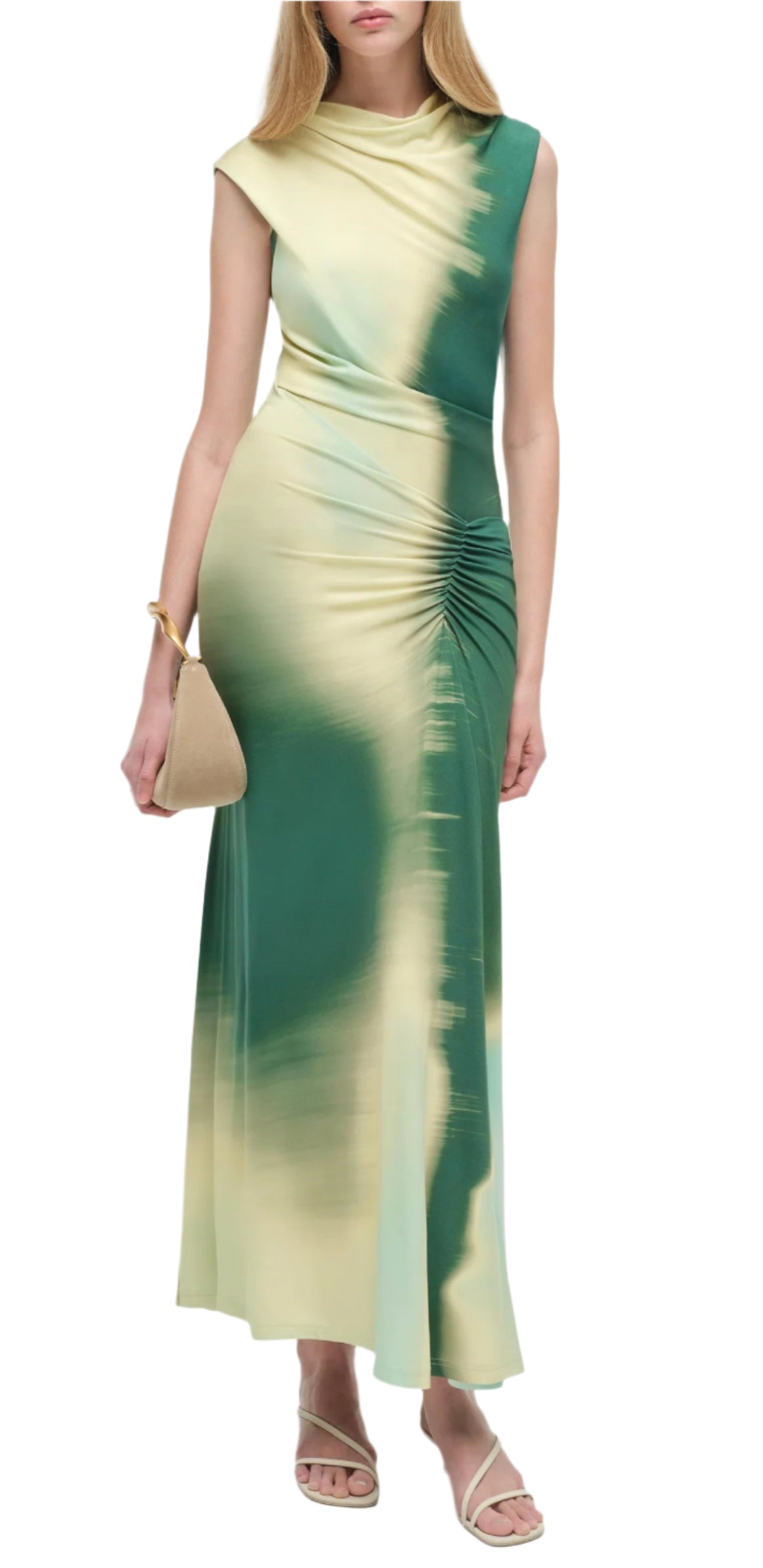 A woman wears the Simkhai Acacia Jersey Midi Dress with a green and beige gradient, featuring an exquisite drape and gathered waist, styled with a tan handbag and beige sandals.