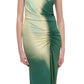 A woman wears the Simkhai Acacia Jersey Midi Dress, featuring a sleeveless design, green-yellow gradient print, midi length, and ruched waist detailing for an elegant drape.