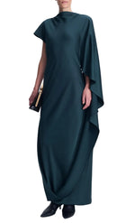 A person wears a dark teal, floor-length, draped satin Ora Satin Gown by Simkhai, featuring an asymmetrical long sleeve and a black clutch.