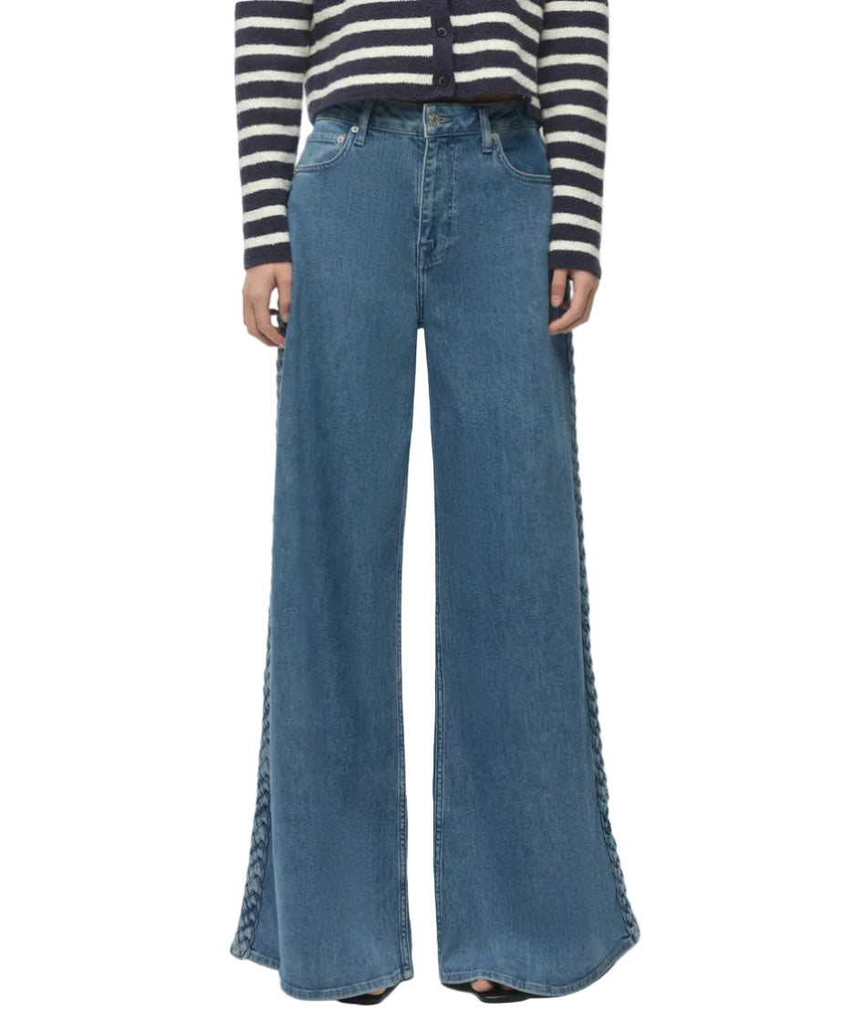 Person wearing Simkhai Booker Straight Jean in blue, styled with lace-up side details, paired with a black-and-white striped long-sleeve top.