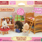 Box of Calico Critters Children’s Bedroom Set, featuring adorable animal figures and detailed dollhouse furniture such as bunk beds, along with charming accessories, all set in a beautifully decorated playroom scene. Ideal for children ages 3 and up.