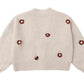 The Rylee & Cru Baby Girls' and Girls' Boxy Crop Cardigan is a beige knit with bubbled sleeves, textured pattern, and red and white flower motifs on the back and sleeves—a cozy addition to any wardrobe.
