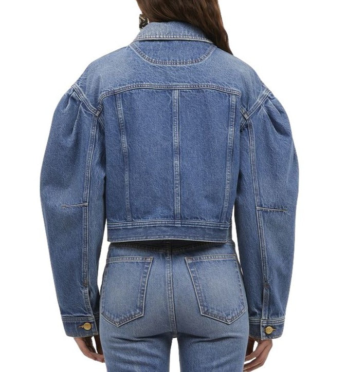 Rear view of a person wearing the Ulla Johnson Cosette Jacket paired with matching premium denim jeans.