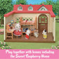 A cozy dollhouse scene with four charming Calico Critters figurines inside, showcasing the Children’s Bedroom Set with delightful dollhouse furniture like a bunk bed, all under a bright red roof, and text about the Sweet Raspberry Home displayed at the bottom.