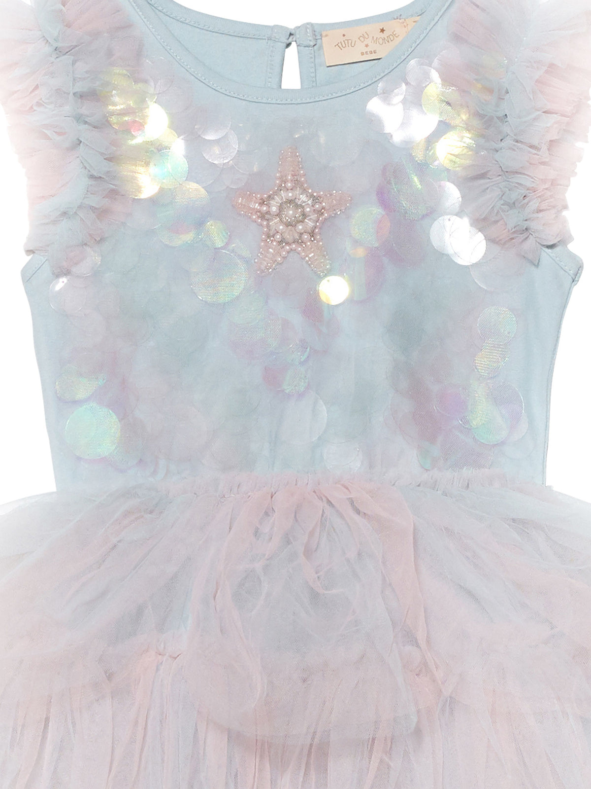 Close-up of the Baby Girls’ Bebe Mermaid Magic Tutu Dress by Tutu du Monde, featuring a light blue and pink color palette, iridescent sequins, and a star-shaped pearl embellishment on the bodice that evokes a whimsical starfish motif.