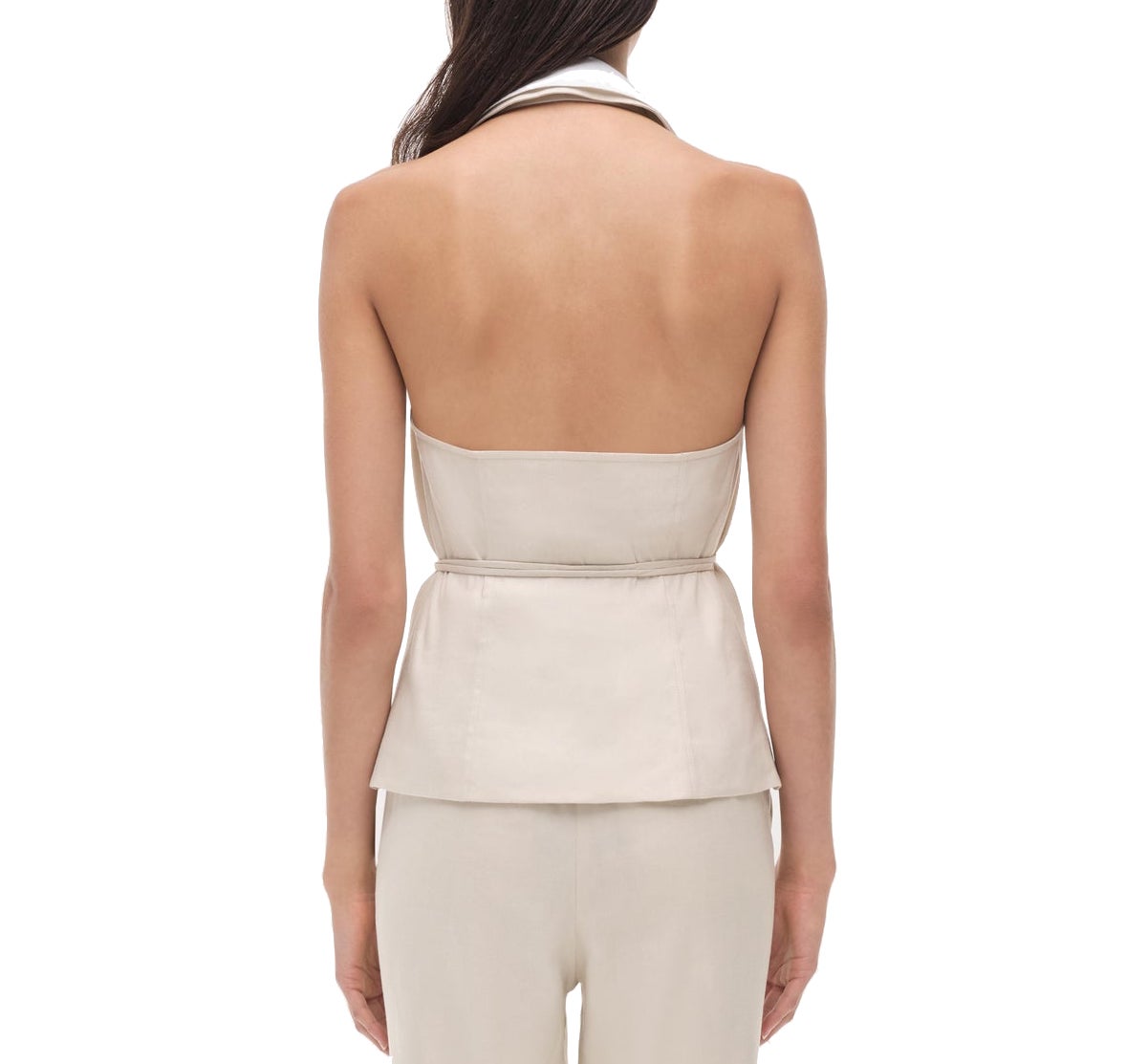 A woman is shown from the back wearing the Simkhai Campbell Halter Shirt and matching pants in a light color against a white background.