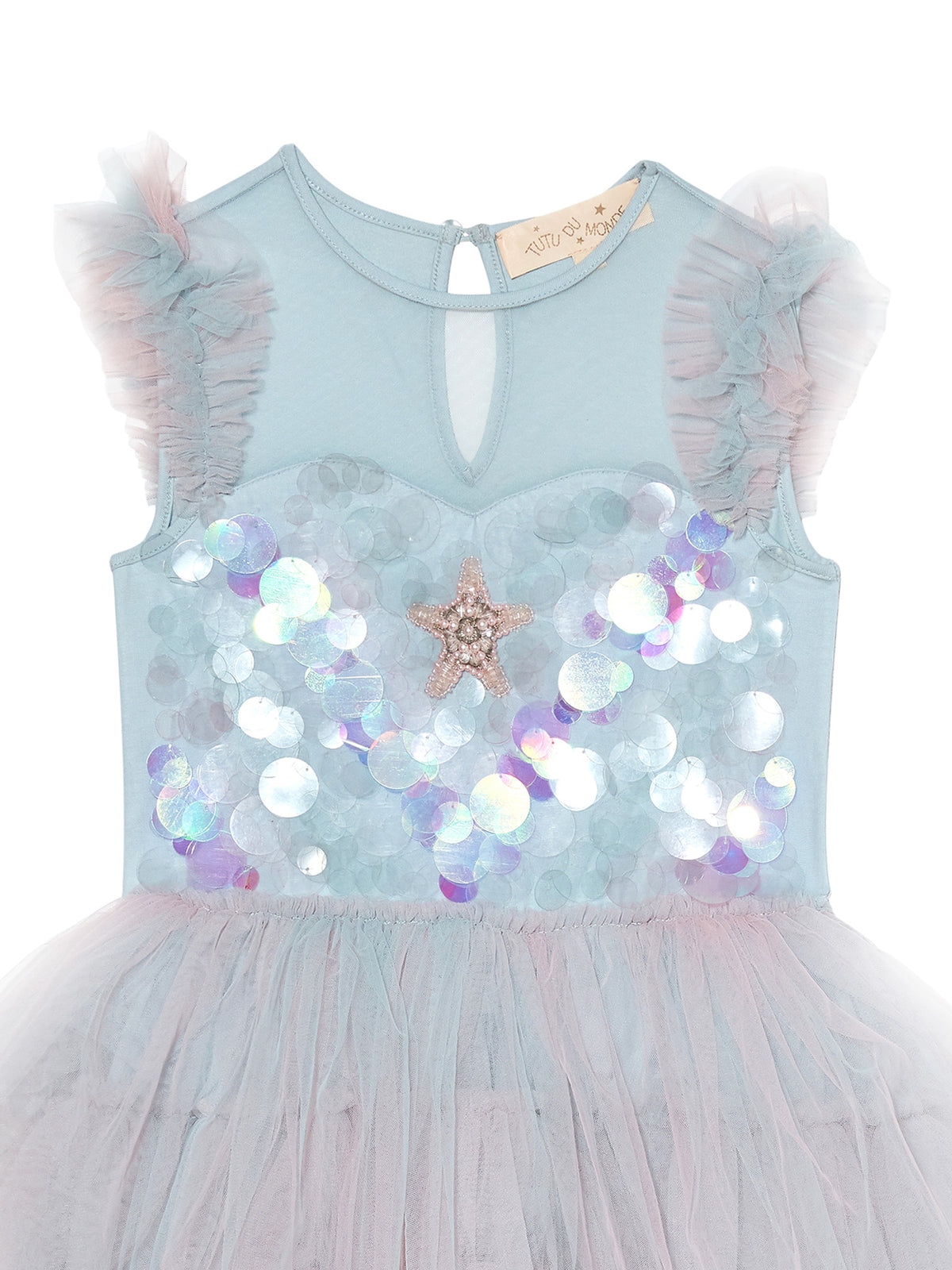 The Girls’ Mermaid Magic Tutu Dress by Tutu du Monde features a light blue sleeveless design with sheer ruffle shoulders, iridescent sequin accents, a sparkling star embellishment on the chest reminiscent of a sequin starfish, and a flowing tulle skirt—perfect for her next mermaid costume or magical dress-up adventure.
