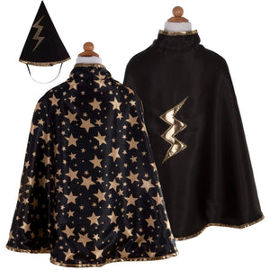 The Great Pretenders Reversible Wizard Cape & Hat set for children includes a black wizard cape decorated with gold stars, a reversible cape featuring a gold lightning bolt, and a black pointed wizard hat accented with a gold lightning bolt.