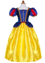 A child-sized mannequin displays the Great Pretenders Fairytale Princess - Snow White dress, featuring a deluxe blue, red, and yellow gown with puffed sleeves and gold trim inspired by the classic fairy tale character. Crafted from premium quality materials, this enchanting princess dress offers magical style for young royalty.