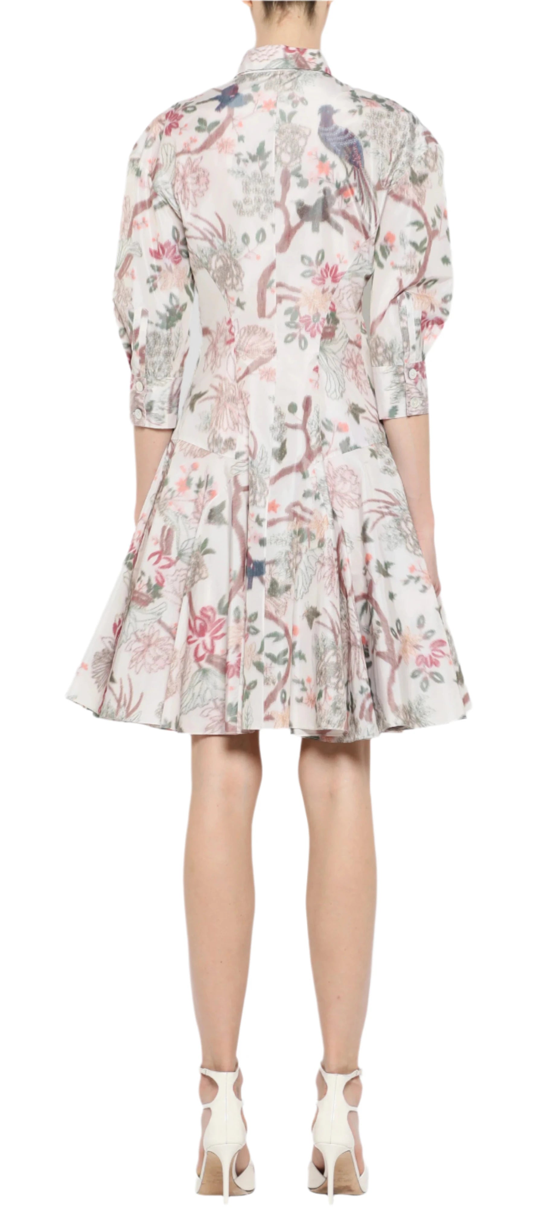 Dressed in a Prabal Gurung Mini Shirtdress with floral and animal prints and puffed sleeves, this knee-length ensemble blends comfort with elegance, paired perfectly with white high heels.