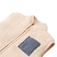 The Baby Orazio Sherpa Vest by Gingersnaps features soft, textured beige fleece, a front zipper, and a navy blue rectangular patch on the left side—making it an ideal plush sherpa gilet for cozy layering.