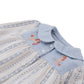 Close-up of the Gingersnaps Baby Girls’ Hester Striped Floral Blouse, a light blue and cream striped top with a Peter Pan collar and delicate embroidered poodles near the neckline.