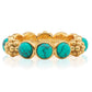 The Berry Gem Ring by Juliska Capucine De Wulf is a gold band adorned with evenly spaced round turquoise stones featuring black veining, accented by delicate gold floral details between each stone.