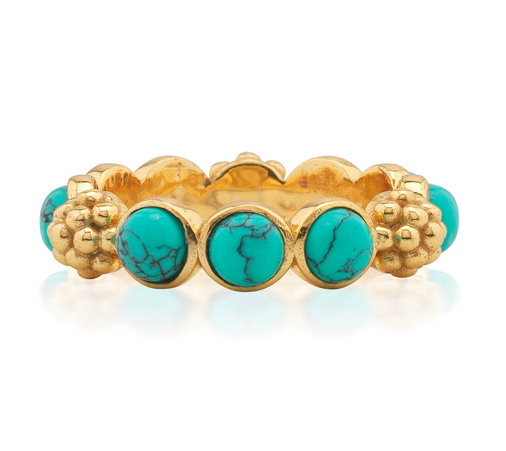 The Berry Gem Ring by Juliska Capucine De Wulf is a gold band adorned with evenly spaced round turquoise stones featuring black veining, accented by delicate gold floral details between each stone.