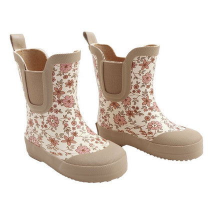 The Quincy Mae Girls' Rain Boots feature a floral pattern in pink and brown, beige soles and trim, and a comfortable rubber lining.