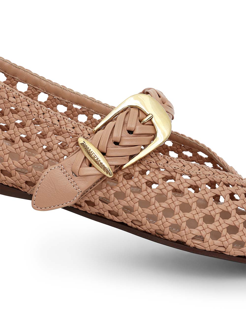 Close-up of the Zimmermann Alchemy Ballerina, a woven tan leather flat featuring gold hardware and a logo-engraved buckle.