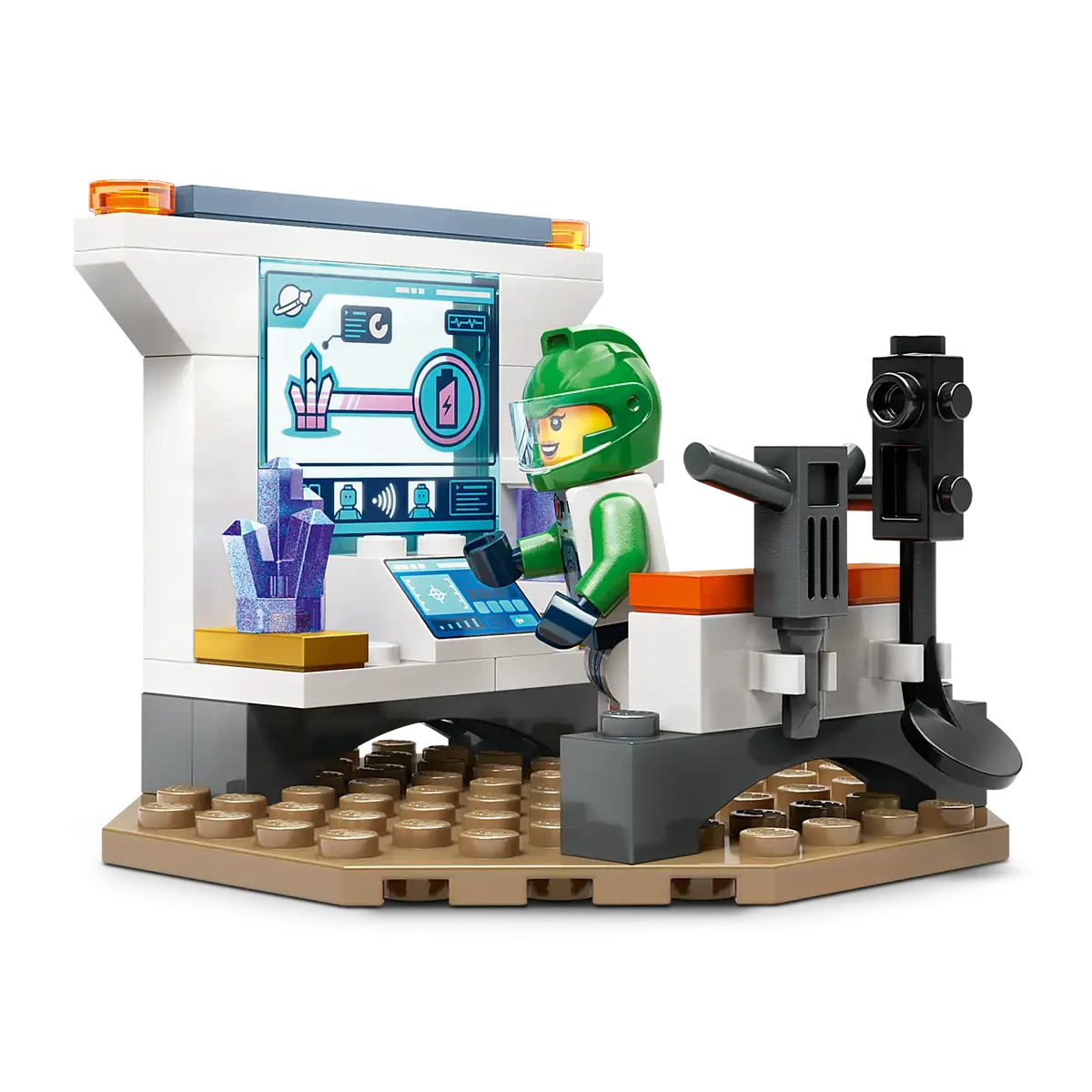 A LEGO astronaut in a green spacesuit engages with a high-tech screen amid a control panel and space decor. This is from the Space Crew Minifigures set, inspired by the thrilling LEGO® City Spaceship and Asteroid Discovery mission by Legos - Toyhouse.