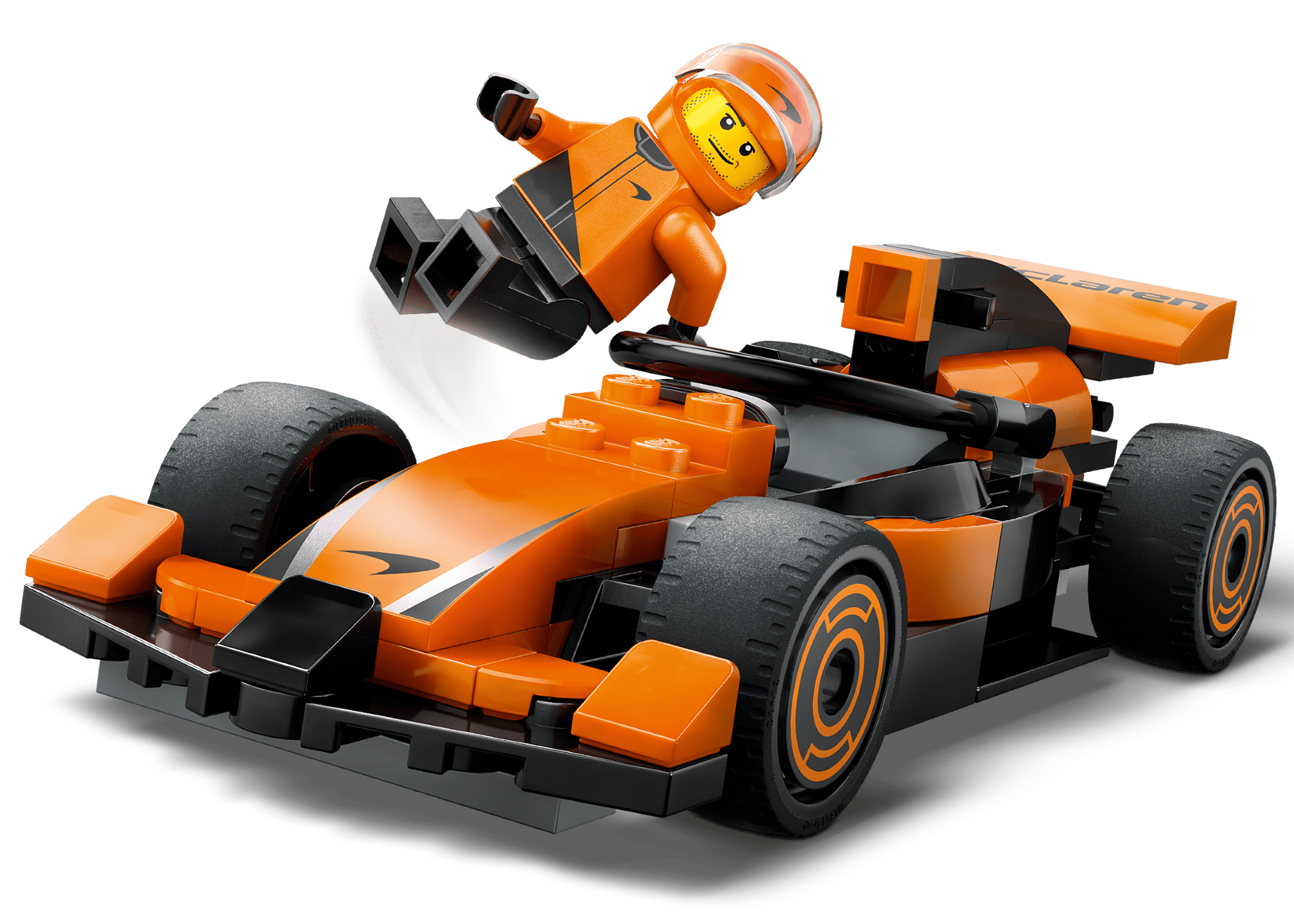 LEGO® City F1® Driver with McLaren Race Car by Legos - Toyhouse features an orange and black F1 toy car with a smiling minifigure in an orange suit and helmet, posed as if leaping from the Formula 1 vehicle.
