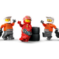 Five LEGO minifigures—one in a red racing suit on tires and four in orange uniforms with tools—gear up for action at the LEGO® City F1® Pit Stop & Pit Crew with Ferrari Car by Legos - Toyhouse.