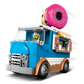 The LEGO® City Donut Truck by Legos - Toyhouse features a blue and white design, a giant pink donut on top, serving window, and a minifigure driver—ideal for fans of the LEGO donut shop theme.