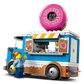 The Legos - Toyhouse LEGO® City Donut Truck features a giant pink donut on top, a serving window, and includes two LEGO figures—one inside the truck and one outside.