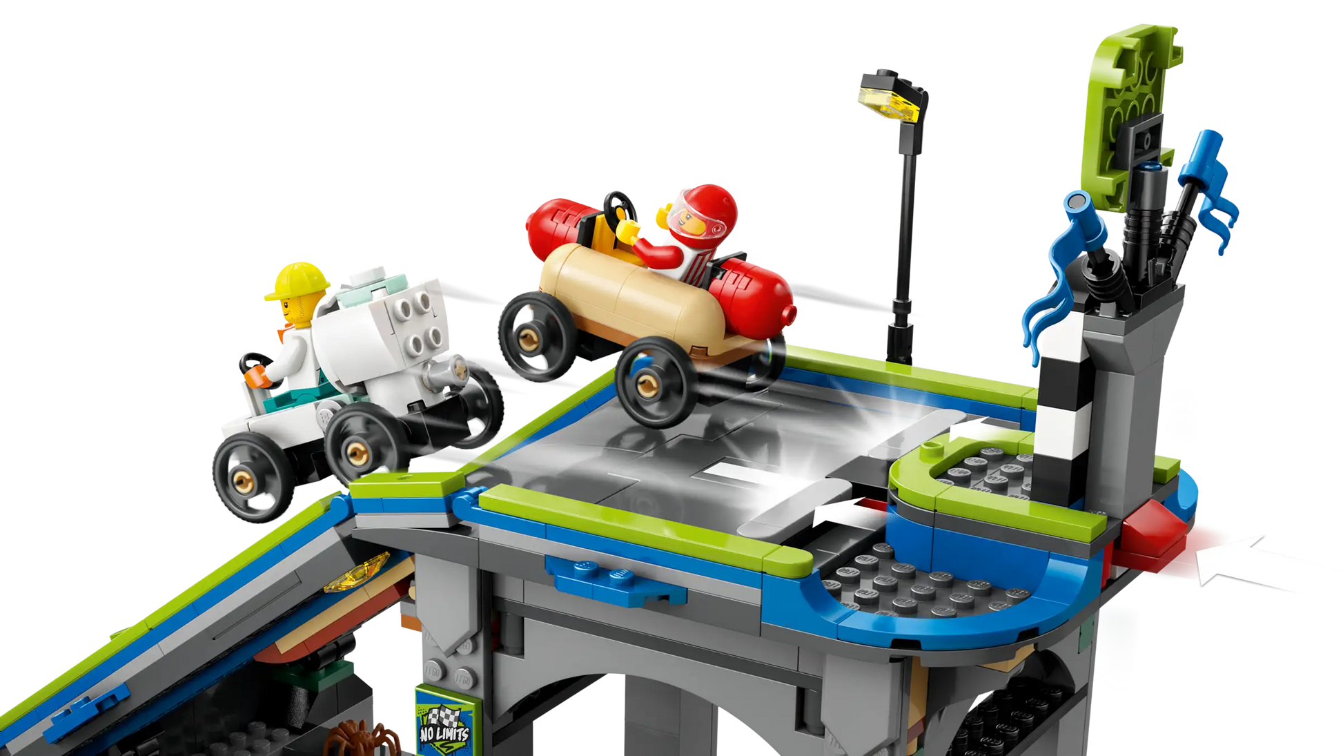 Two toy figures race small cars on the LEGO® City No Limits: Race Car Ramp Track by Legos - Toyhouse, with ramps, a streetlight, and traffic signs—perfect for thrilling soapbox racing adventures.